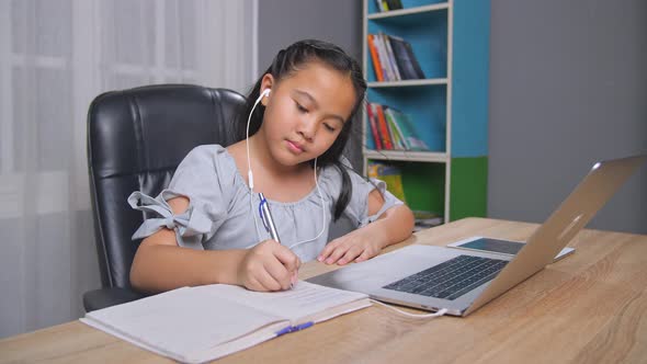 girl writing and use laptop